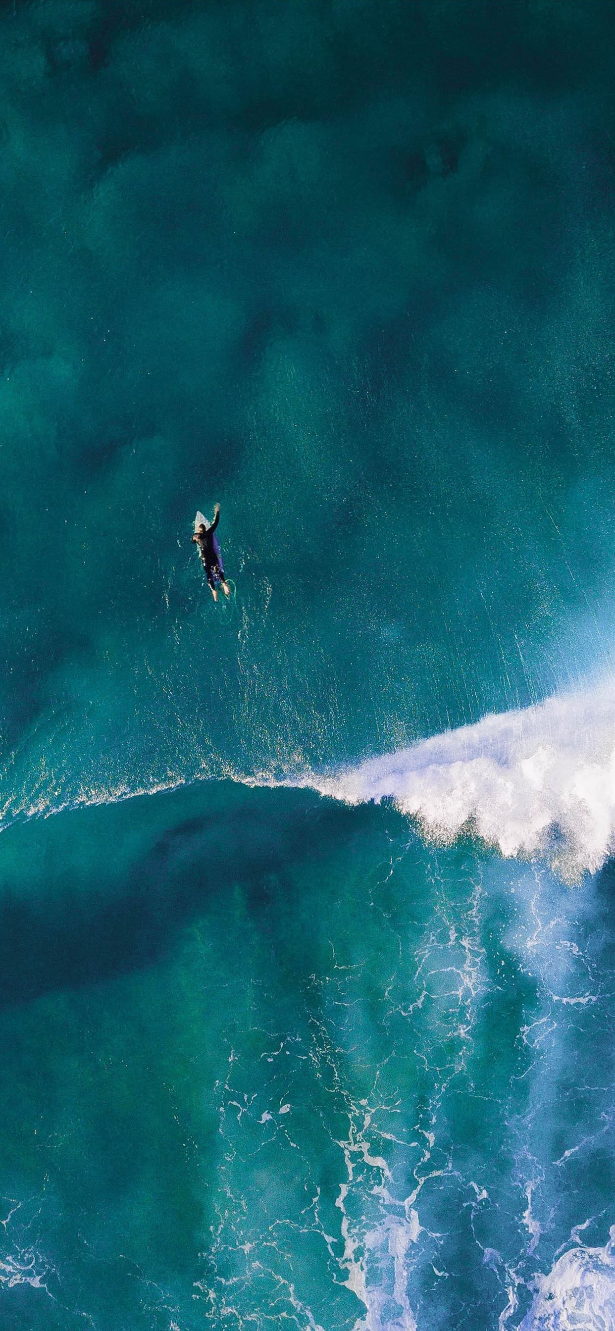 person surfing iPhone X Wallpapers Free Download