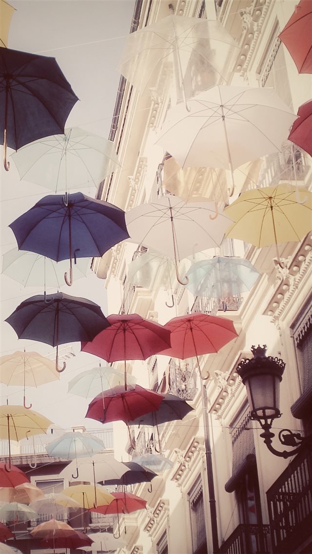 Floating Colorful Umbrellas In City iPhone 8 wallpaper 