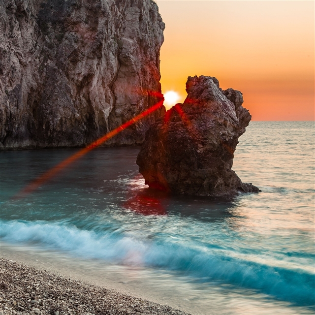 Sun beams rocks block progal sea coast stones wave iPad Pro wallpaper 