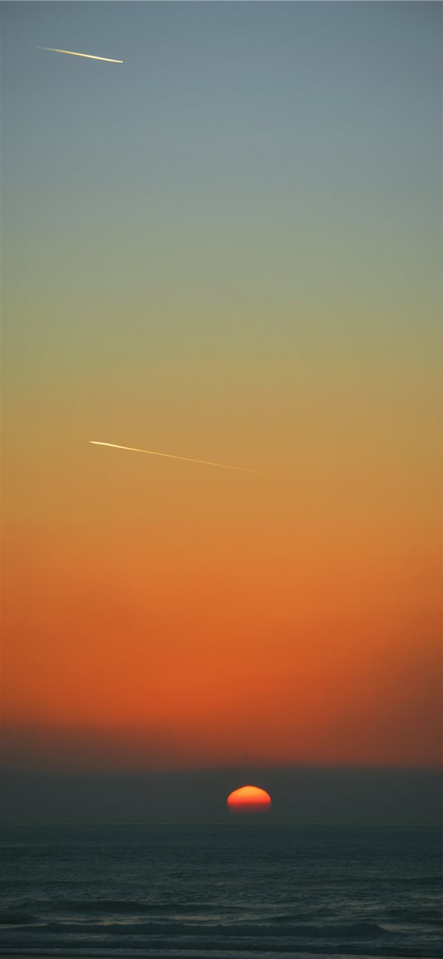 Shooting stars and setting sun iPhone X wallpaper 