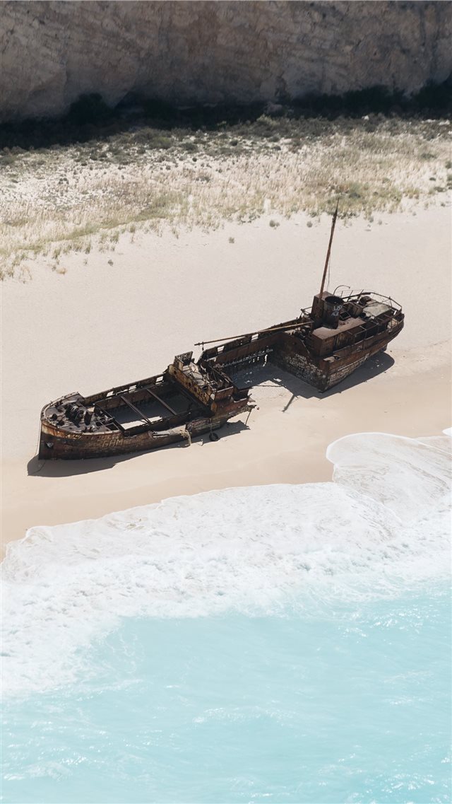 wrecked brown ship on seashore iPhone 8 wallpaper 