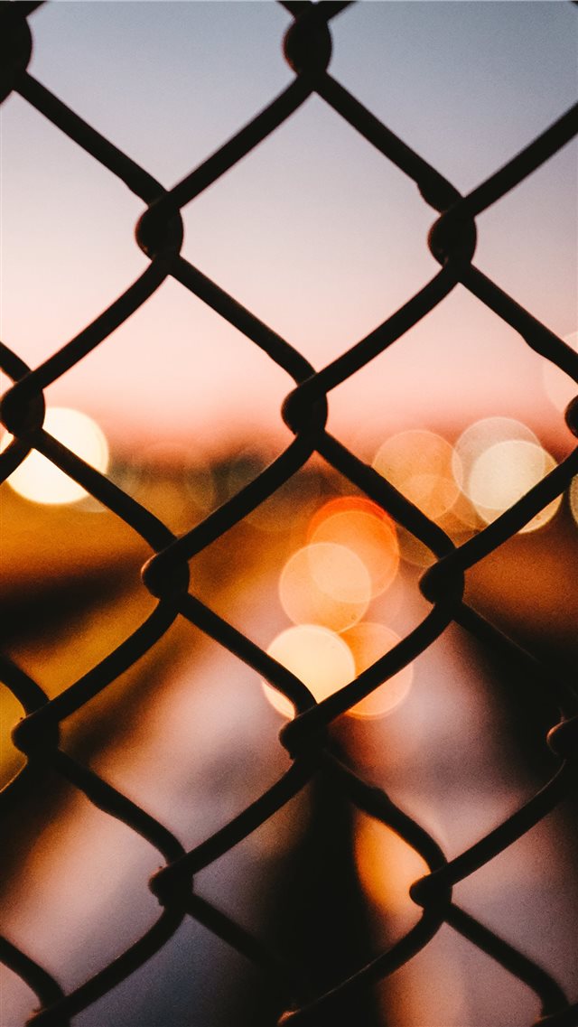 Bokeh behind a fence iPhone 8 wallpaper 