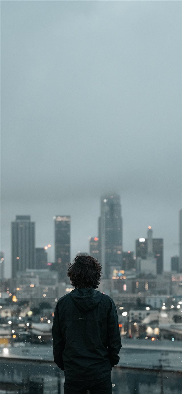 person standing an looking down iPhone X wallpaper 