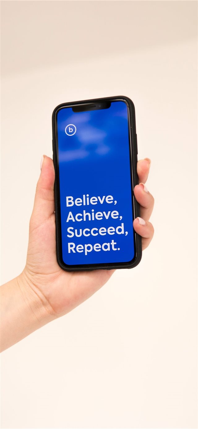 hand holding iphone x with cool quote iPhone X wallpaper 