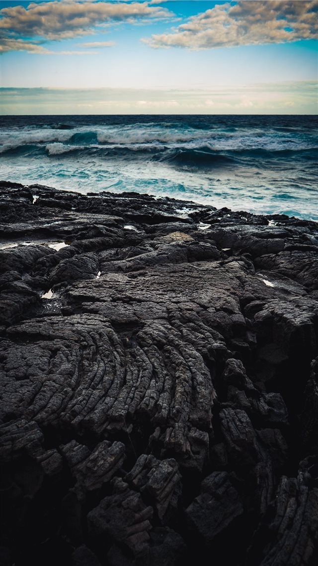Dusk over a field of lava bordering the Pacific Oc... iPhone 8 wallpaper 