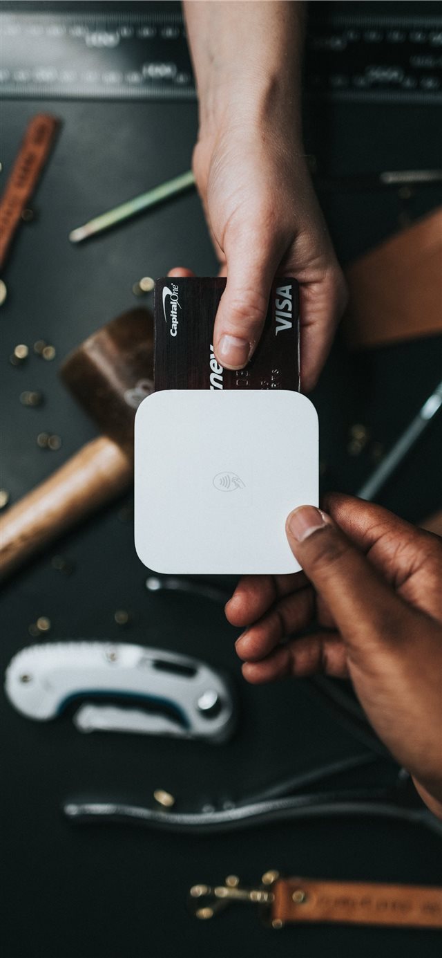 person holding Visa card and white device iPhone X wallpaper 