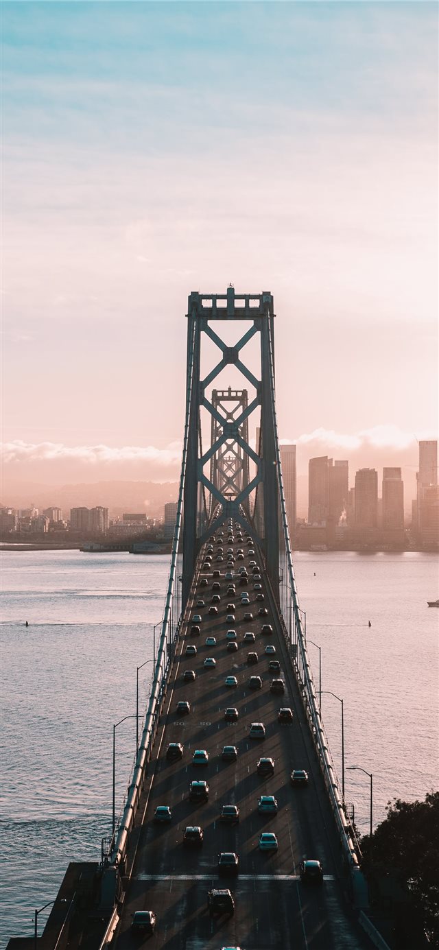 aerial photo of vehicles traveling on bridge durin... iPhone X wallpaper 