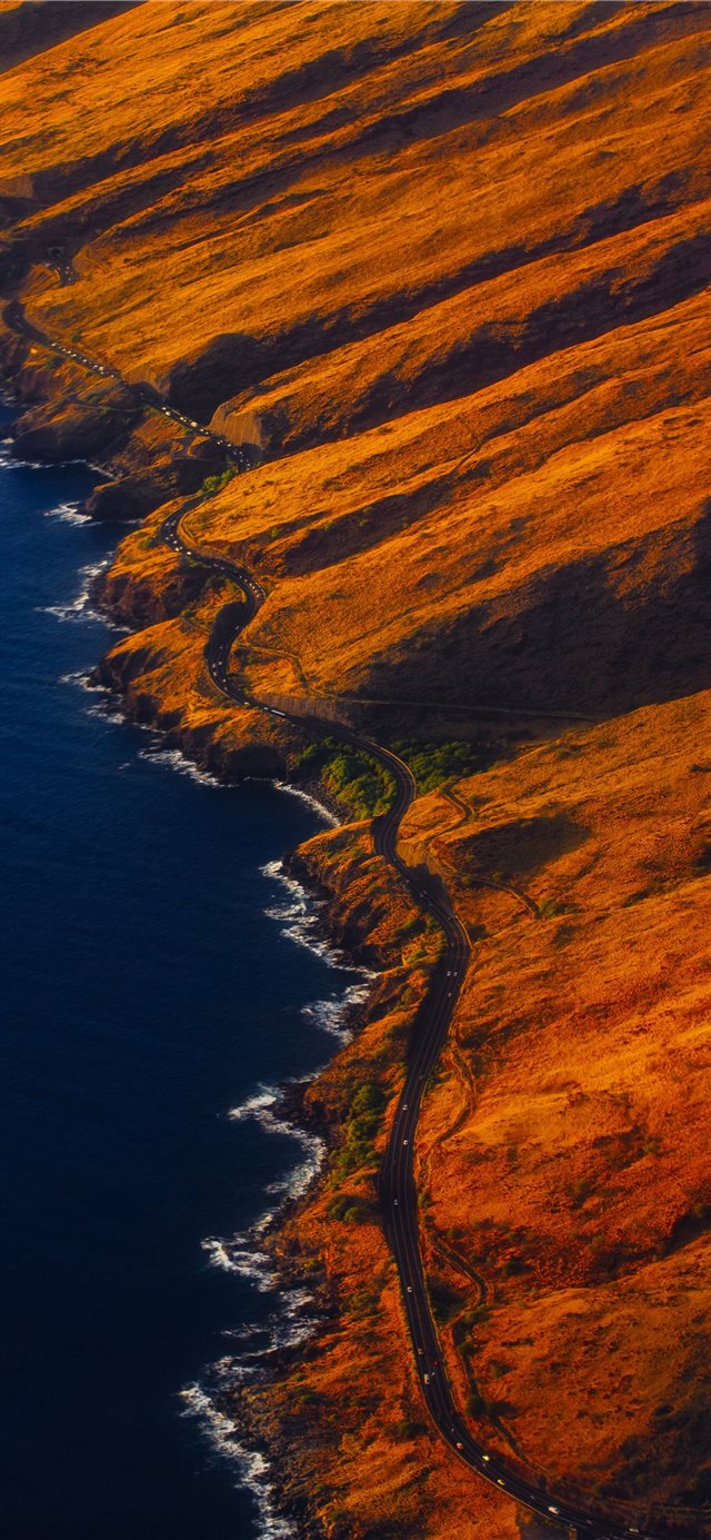 aerial photography of road on mountain near seasho... iPhone 11 wallpaper 