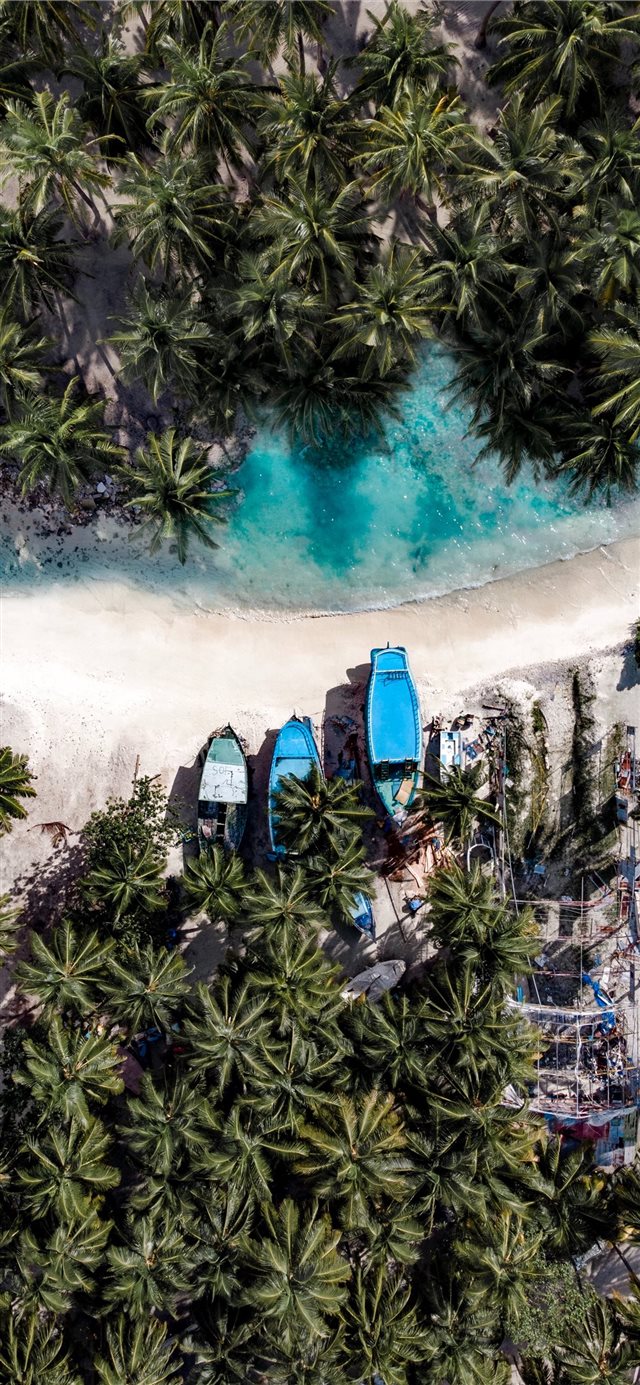 aerial photography of three boats on island iPhone 11 wallpaper 