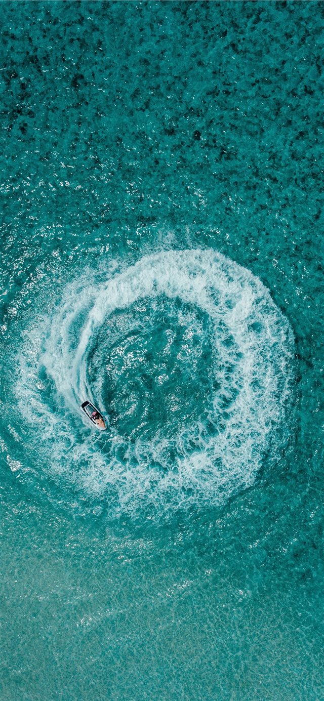 aerial shot person riding on personal watercraft iPhone X wallpaper 