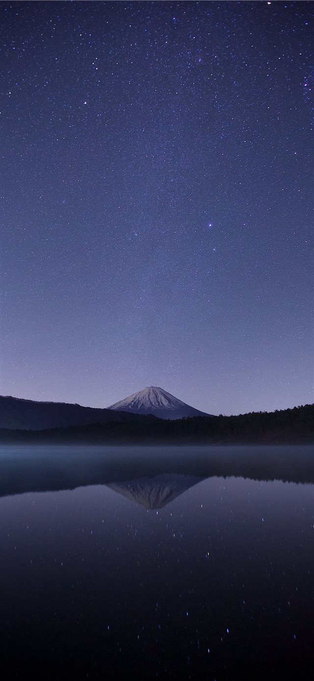 calm body of water near alp mountains during night... iPhone X wallpaper 