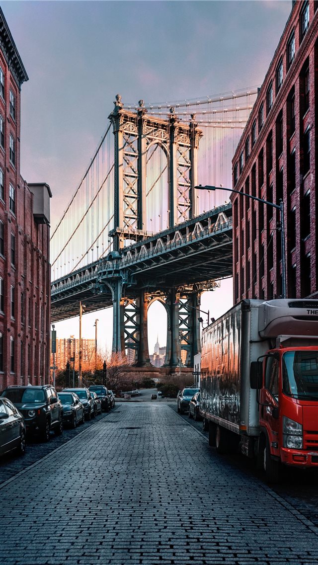 cars parked on both sides of street near bridge iPhone 8 wallpaper 