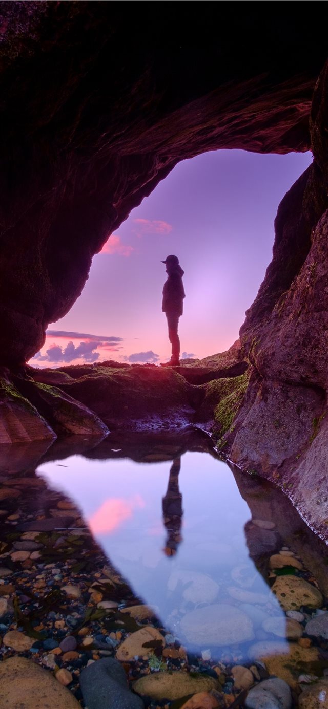 man standing in front of cave iPhone 11 wallpaper 