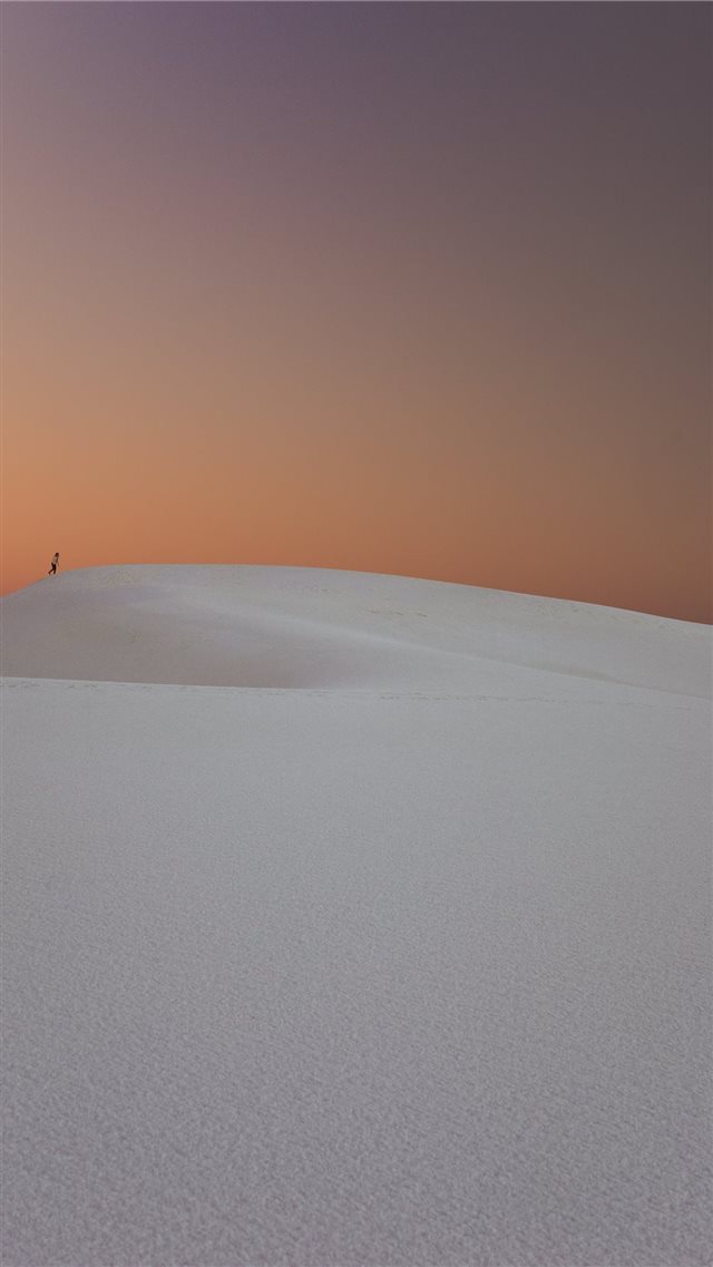 person walking in the desert dunes iPhone 8 wallpaper 
