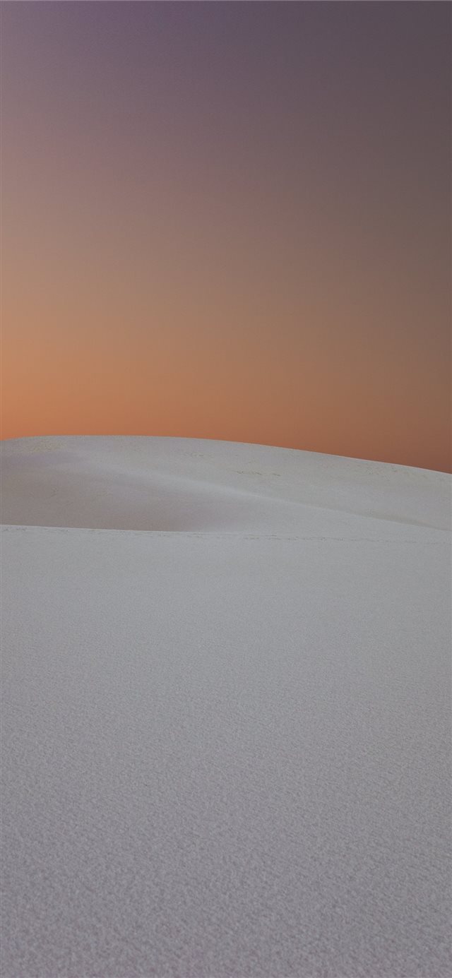 person walking in the desert dunes iPhone X wallpaper 