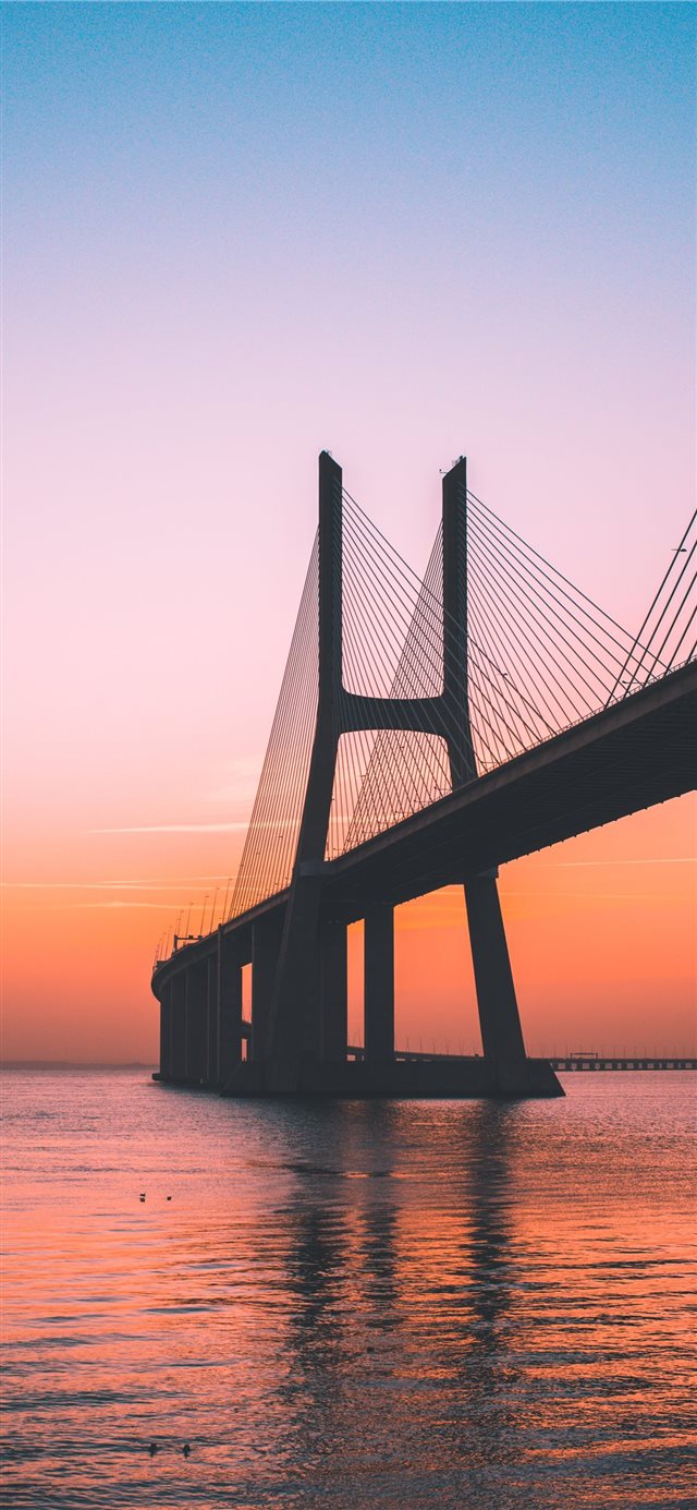 silhouette of bridge under clear sky iPhone X wallpaper 