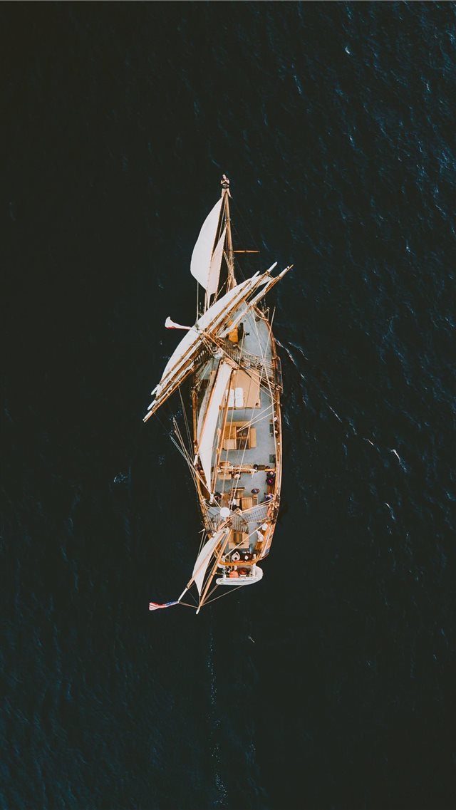 aerial photography of brown galleon ship on body o... iPhone 8 wallpaper 