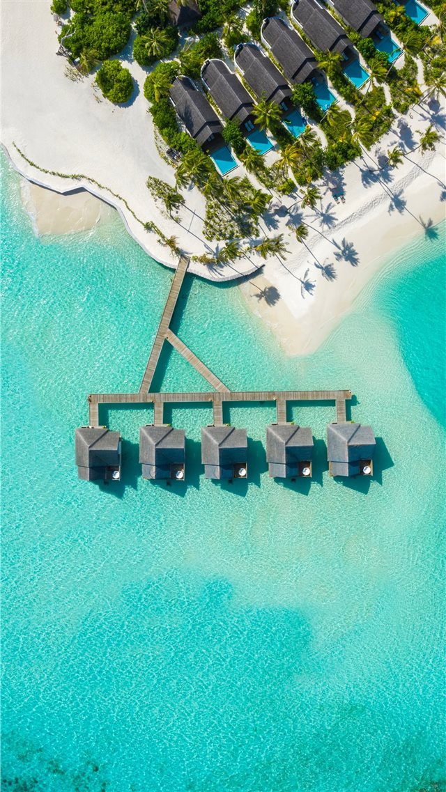 brown huts on body of water in aerial photography iPhone 8 wallpaper 