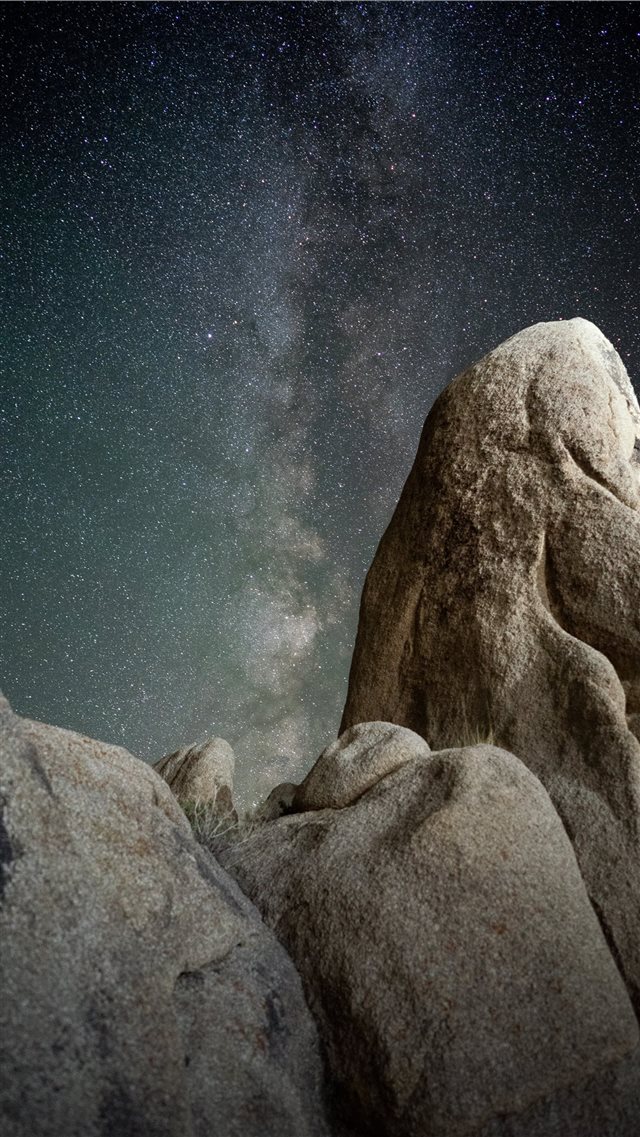brown rock formations under starry night iPhone 8 wallpaper 