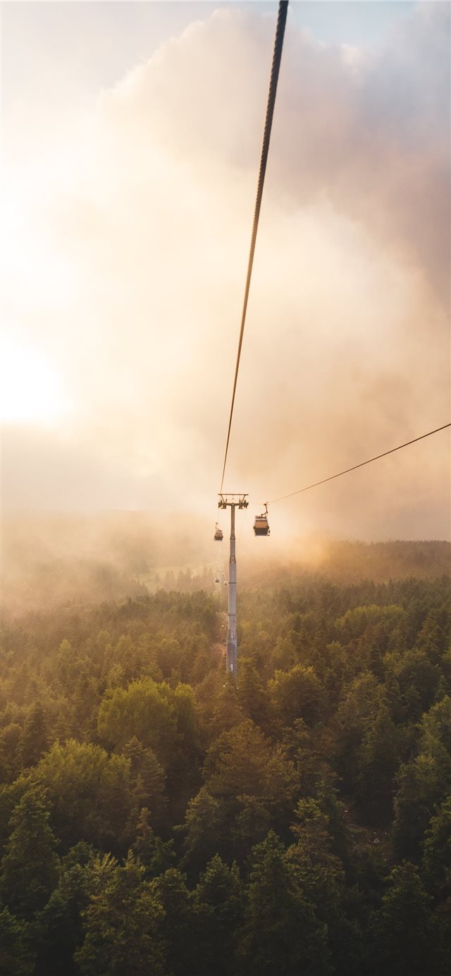 cable car under brown and white sky iPhone X wallpaper 