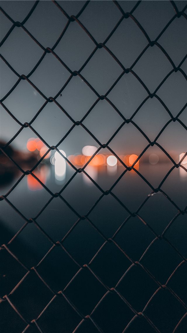 chain link fence behind bokeh iPhone SE wallpaper 