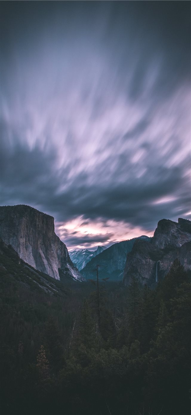 landscape photo of mountains under cloudy sky iPhone 11 wallpaper 