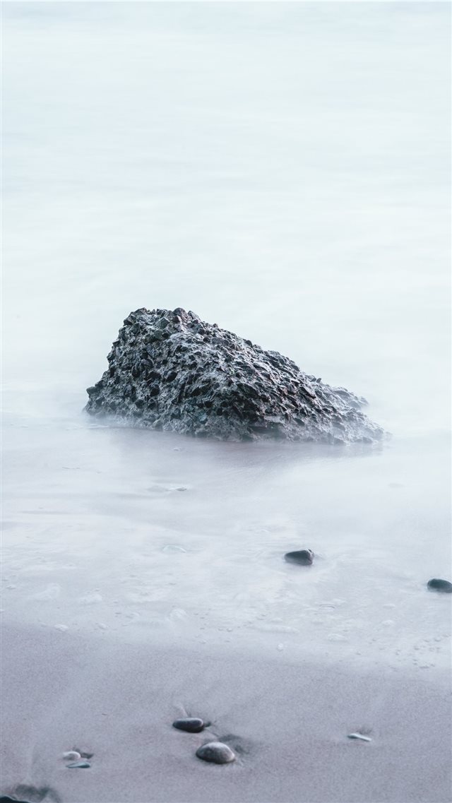rock on sand shore during day iPhone 8 wallpaper 