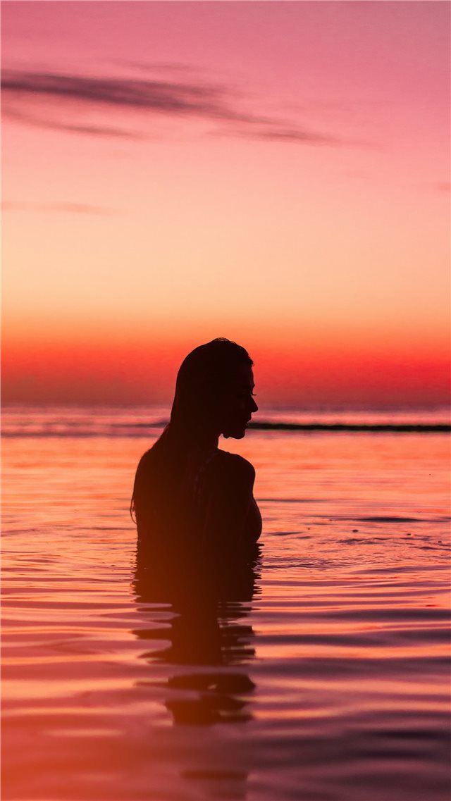 silhouette of woman in body of water iPhone 8 wallpaper 