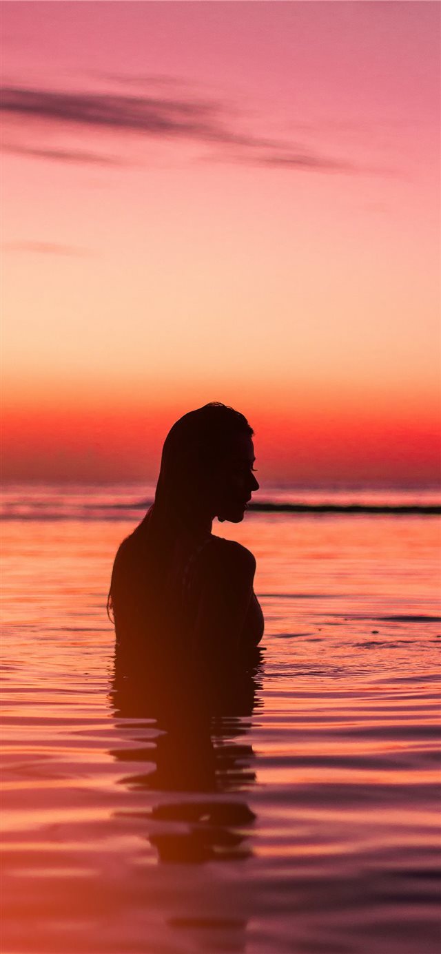 silhouette of woman in body of water iPhone X wallpaper 