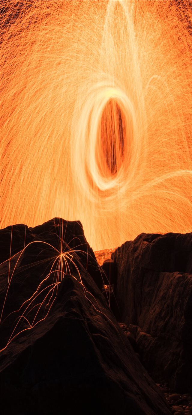 steel wool photography of brown rock formations iPhone X wallpaper 