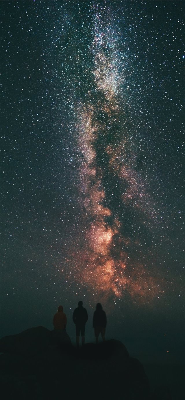 three person looking stars and milky way iPhone X wallpaper 