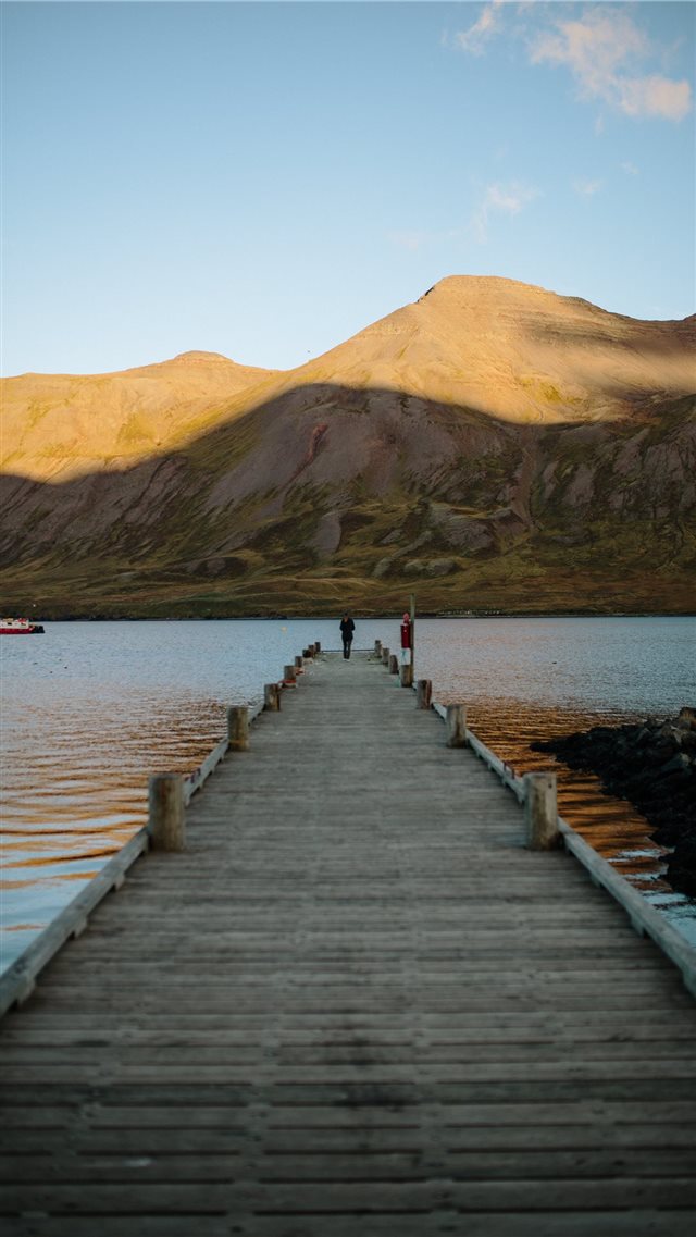 person standing at edge of dock iPhone 8 wallpaper 