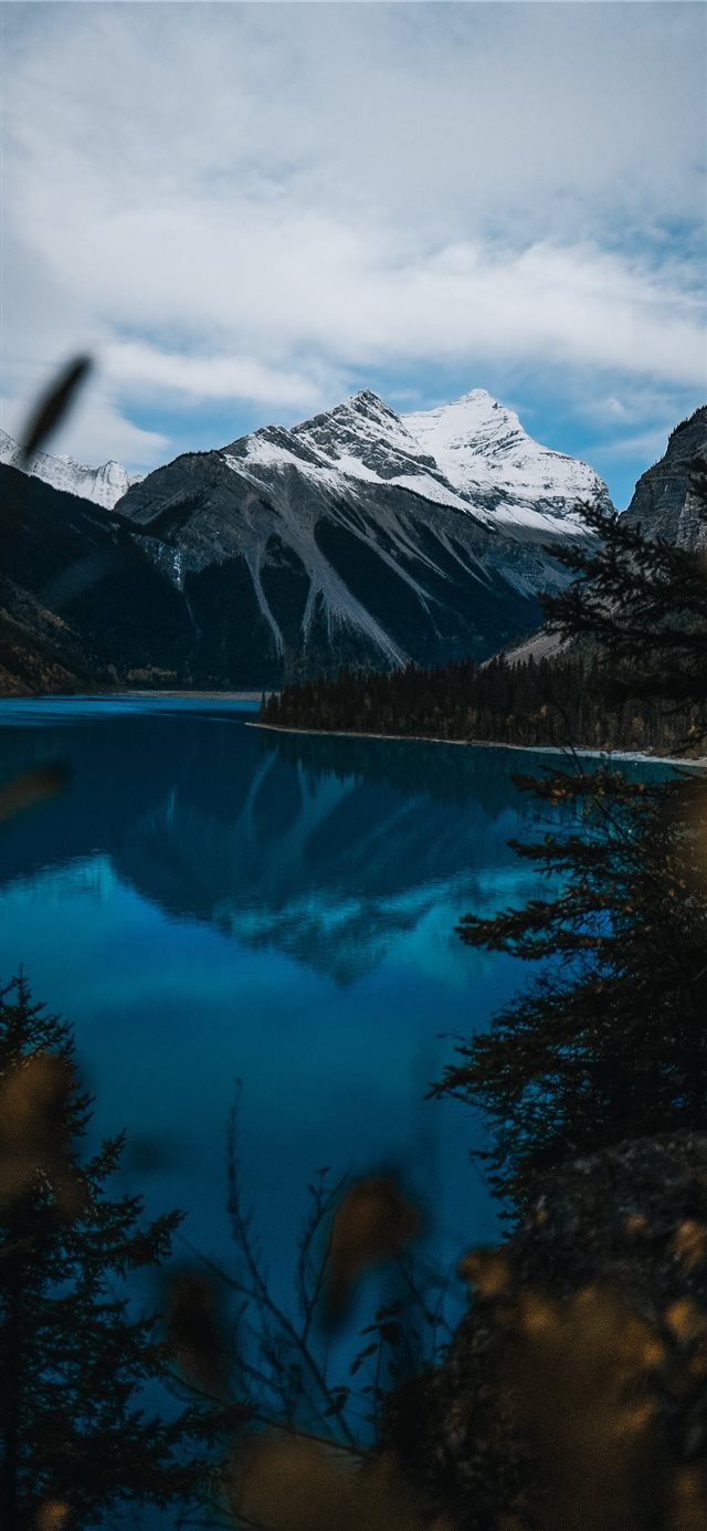 body of water near snow covered mountain during da... iPhone 11 wallpaper 