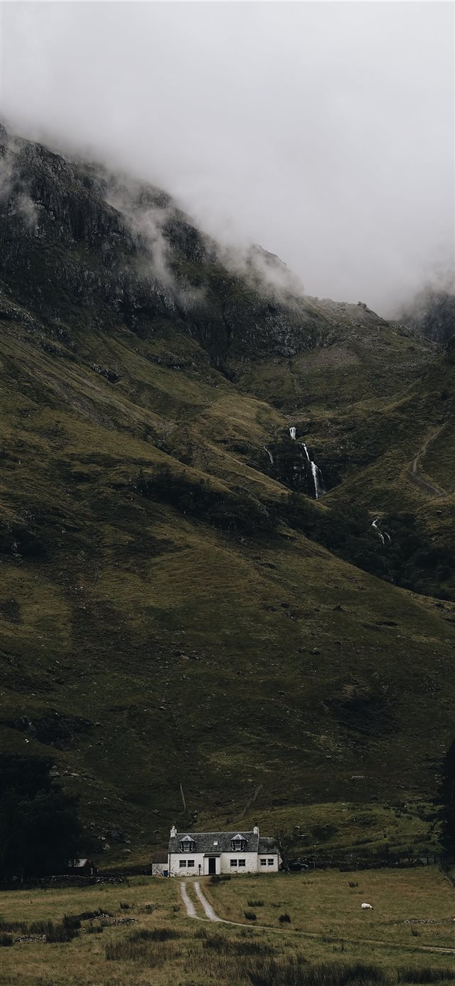 landscape photography of house under mountain iPhone X wallpaper 