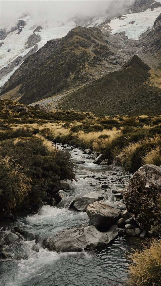 water stream near mountains iPhone 8 wallpaper 