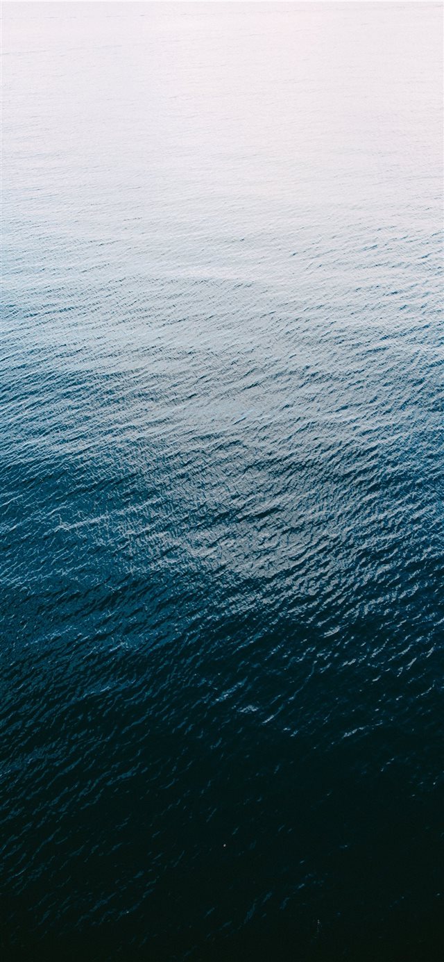 A shot of the Pacific Ocean from above iPhone X wallpaper 