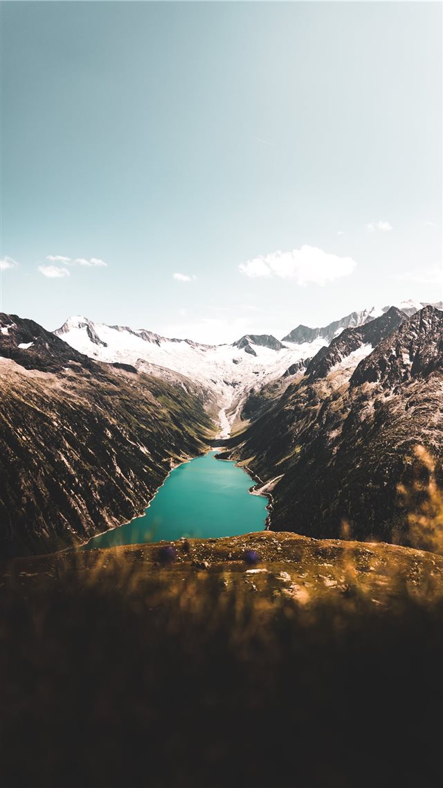 aerial photography of body of water between mounta... iPhone 8 wallpaper 