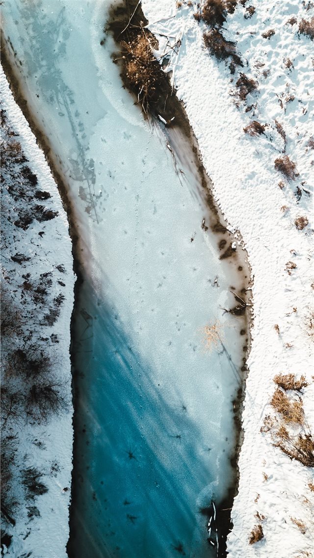 aerial photography of river beside snow field iPhone 8 wallpaper 