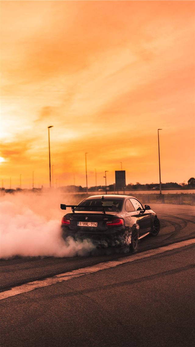 black car drifting on road during day iPhone 8 wallpaper 