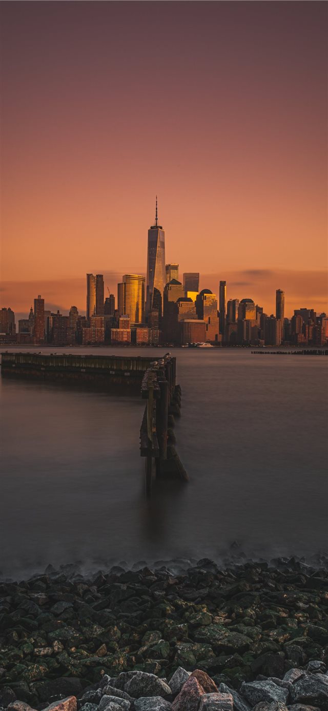 city and body of water during golden hour iPhone X wallpaper 