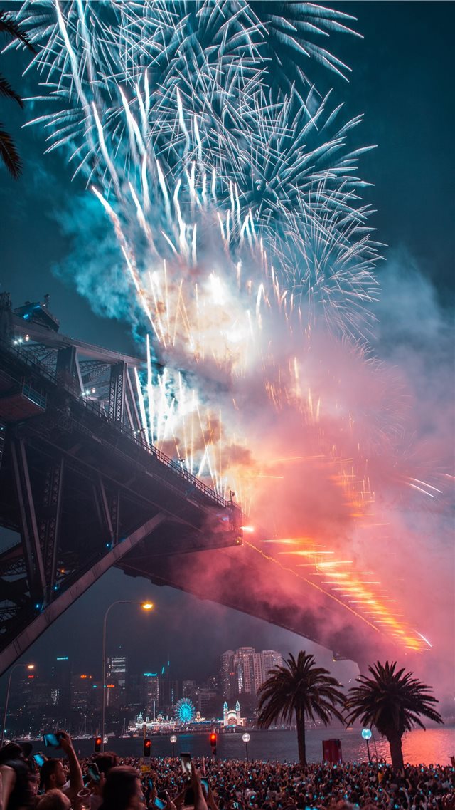 fireworks on bridge during night time iPhone 8 wallpaper 
