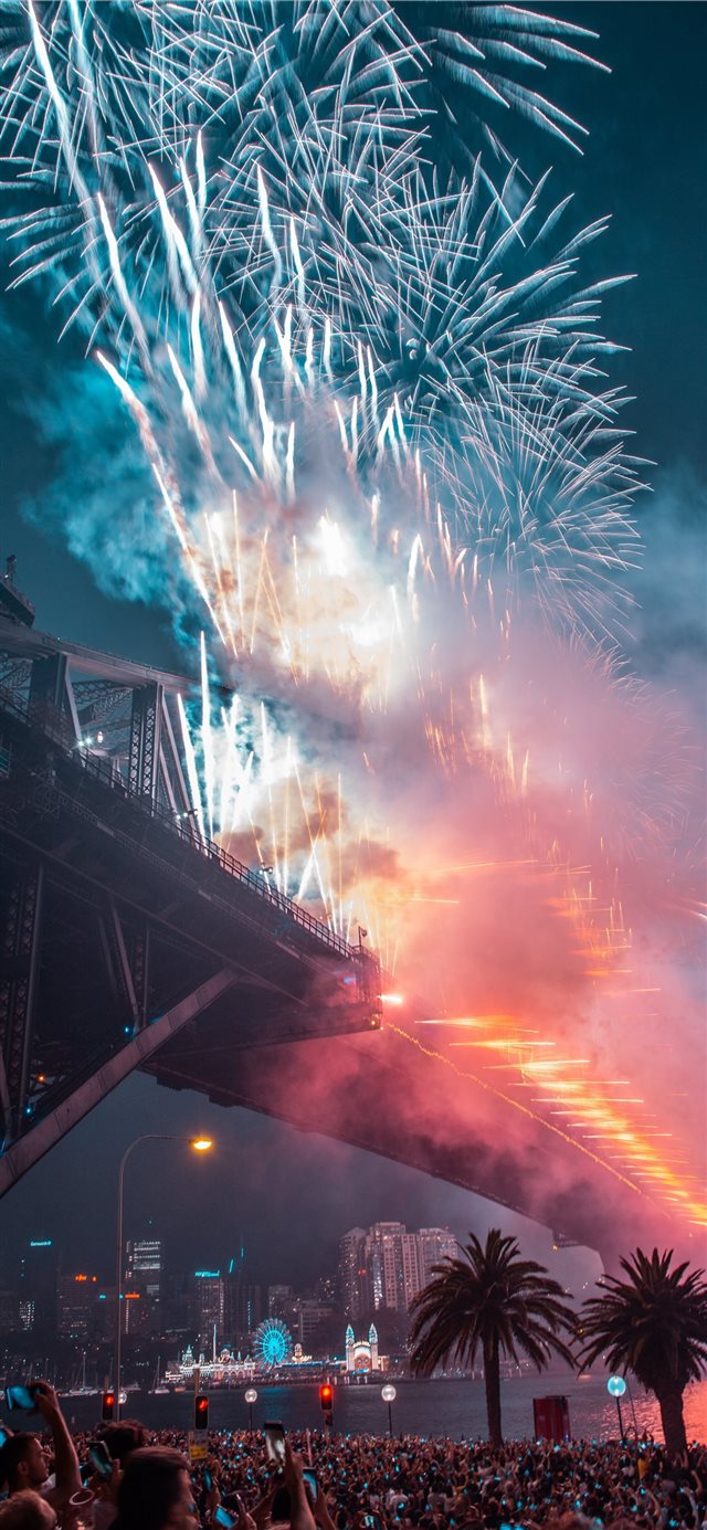 fireworks on bridge during night time iPhone X wallpaper 