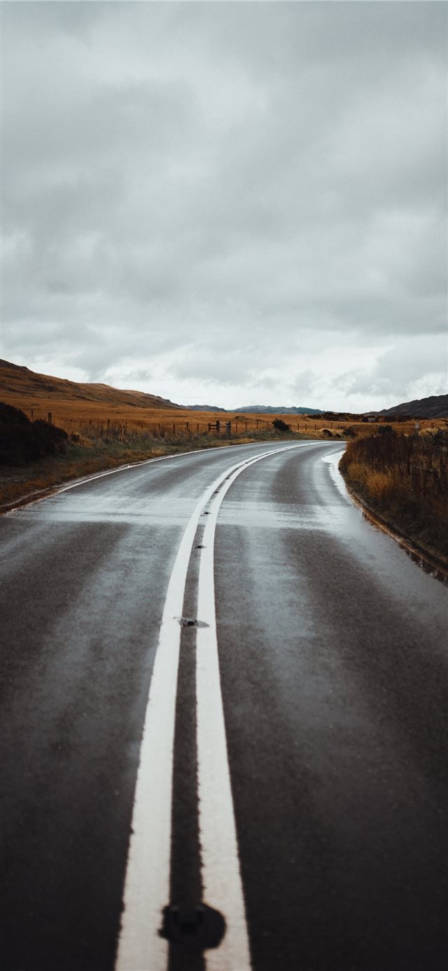 road under cloudy sky iPhone X wallpaper 
