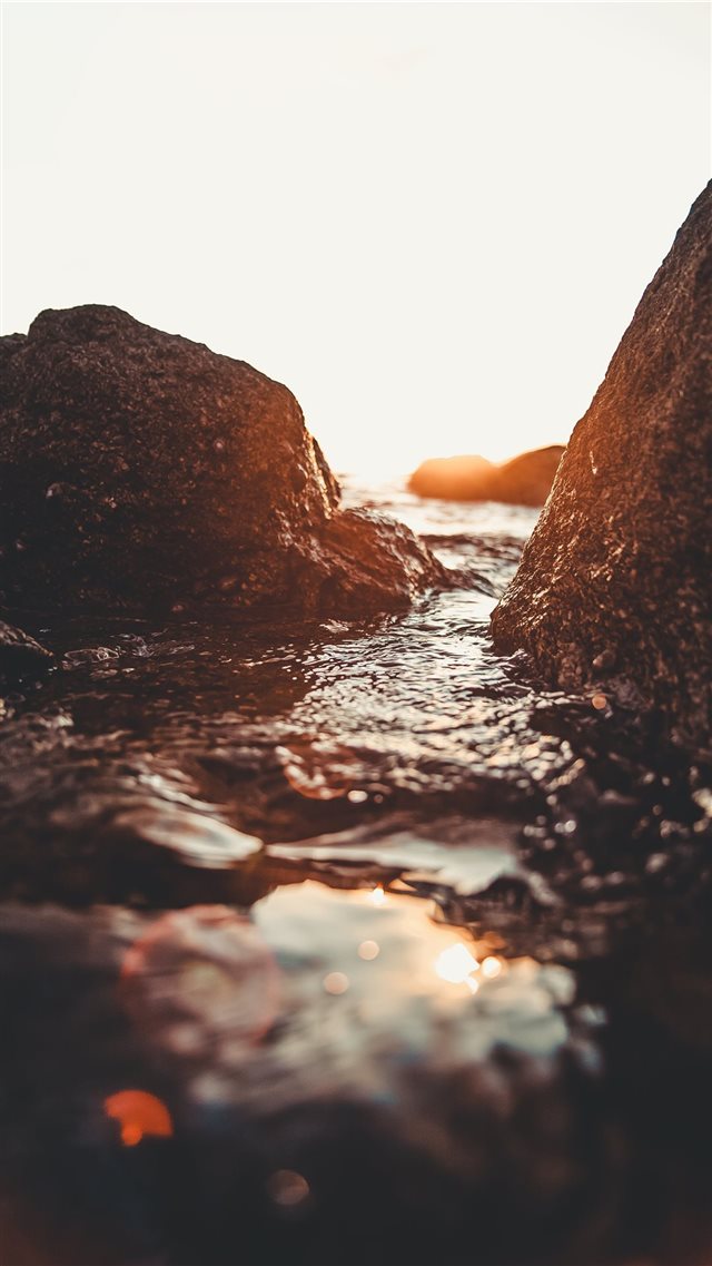 rocky seashore during golden hour iPhone 8 wallpaper 