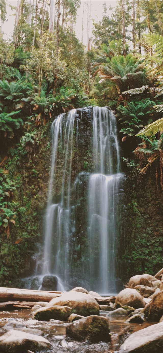 timelapse photo of waterfall facing rocks iPhone X wallpaper 