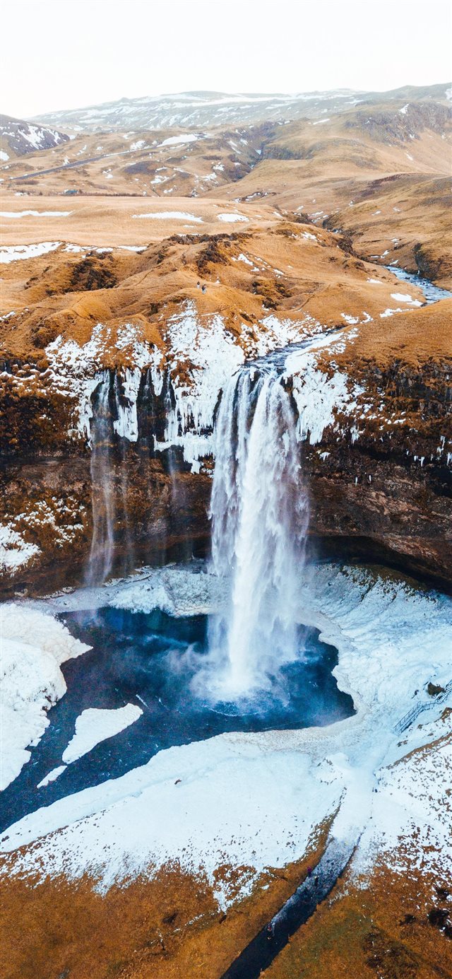 aerial photography of waterfalls near mountains at... iPhone X wallpaper 