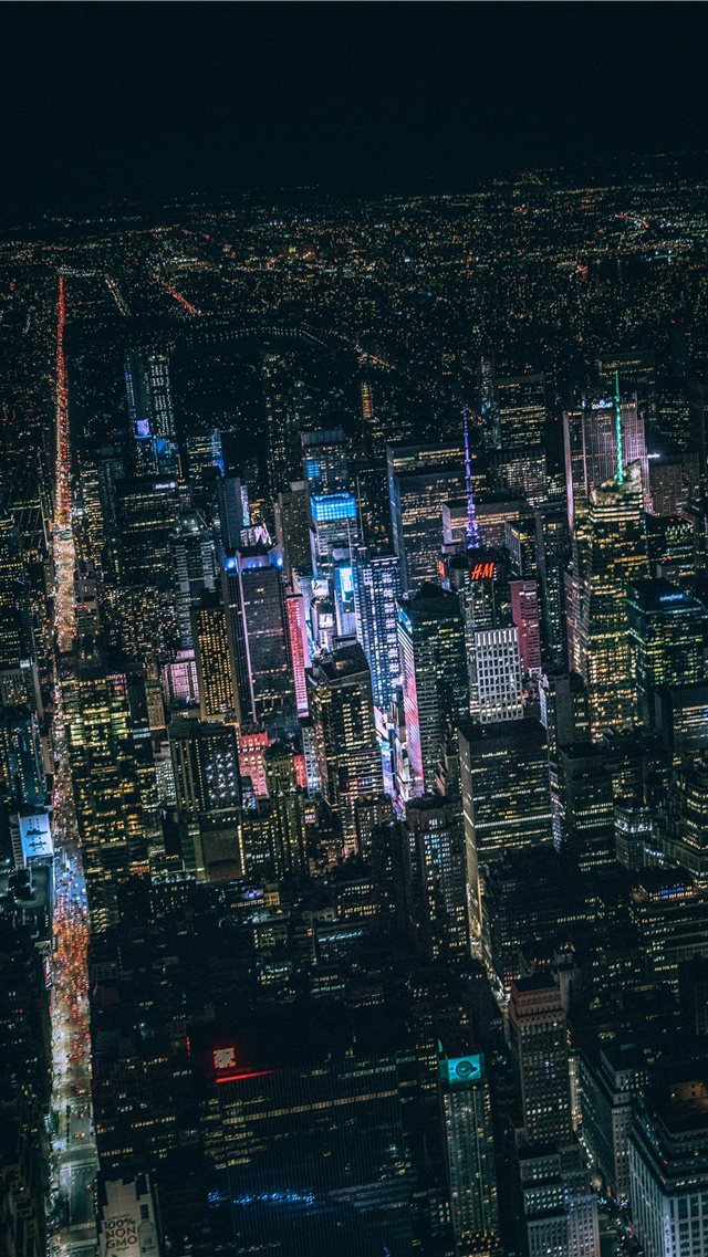 aerial view of city buildings during night time iPhone 8 wallpaper 