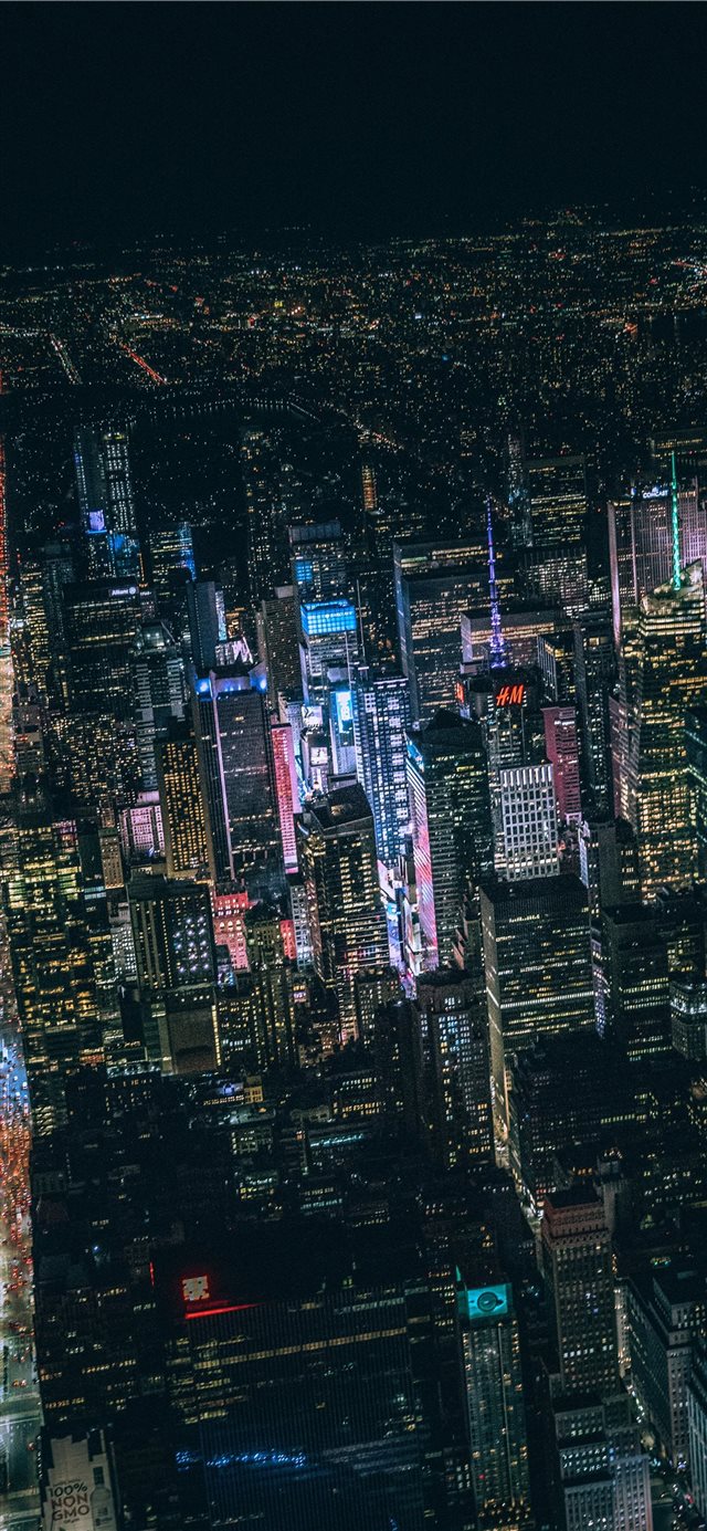 aerial view of city buildings during night time iPhone X wallpaper 