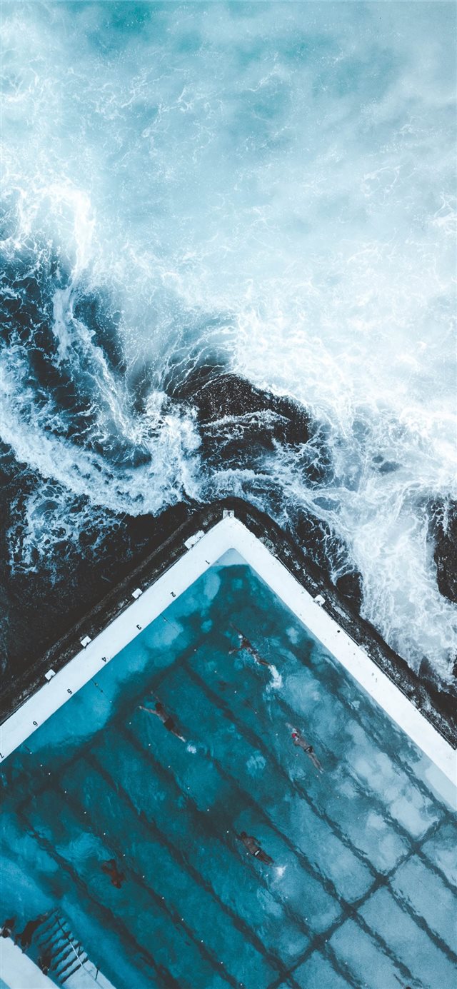 aerial view of ocean beside dock iPhone 11 wallpaper 