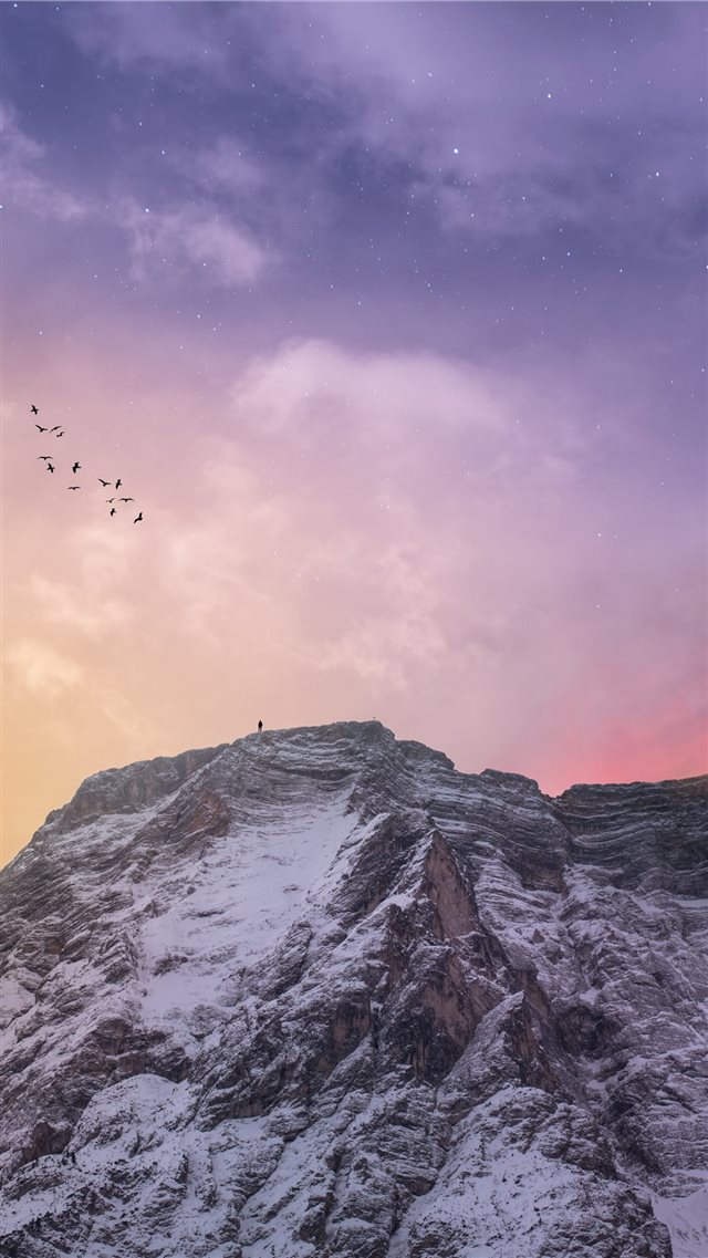 mountain covered with snow under blue and orange s... iPhone 8 wallpaper 